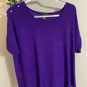 Shimmery purple shirt with silver studs on shoulders.
